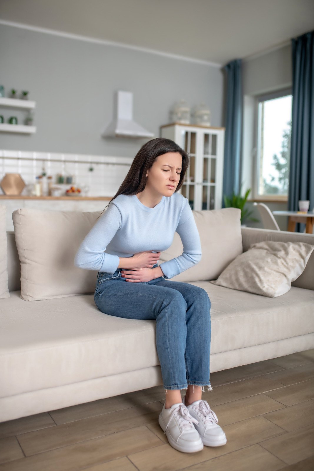 Digestibility disorder. A young woman having a shomach ache